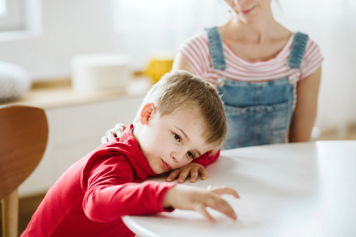 child on desk thinking